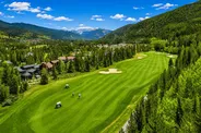 Golf course homes beside a fairway in Keystone, Colorado, surrounded by forested mountains